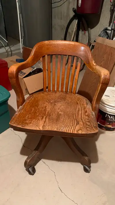 Solid oak vintage swivel desk chair. The wood is in excellent shape but the chair does need refinish...