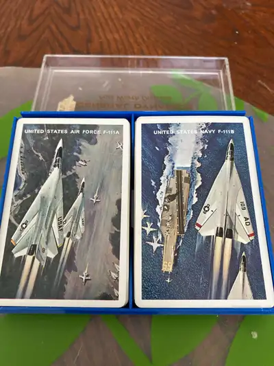 This US Air Force and Navy double card deck, complete with its original case, features striking imag...