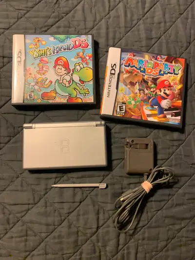 Metallic Silver Nintendo DS Lite with Yoshi’s Island & Mario Party games. Comes with charger and sty...
