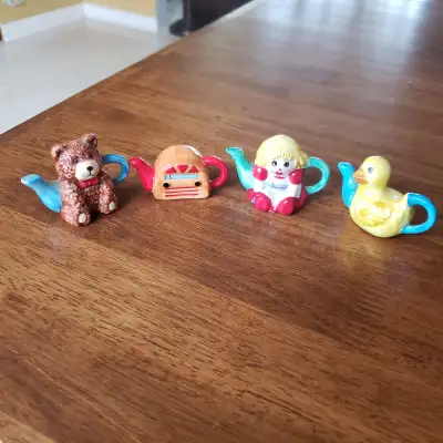 Here are four different Red Rose mini tea pots. Radio, Duck, Bear and Doll......some minor paint wea...