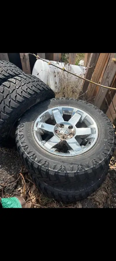 Set of 4 ram rims and tires , rubber is weather cracked , rims are okay