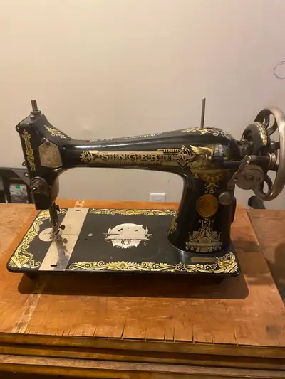 Selling a vintage singer sewing machine with cabinet, View more