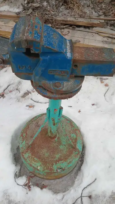 This is a Record No. 4 bench vise mounted on a sturdy stand. It's definitely seen some action and ha...