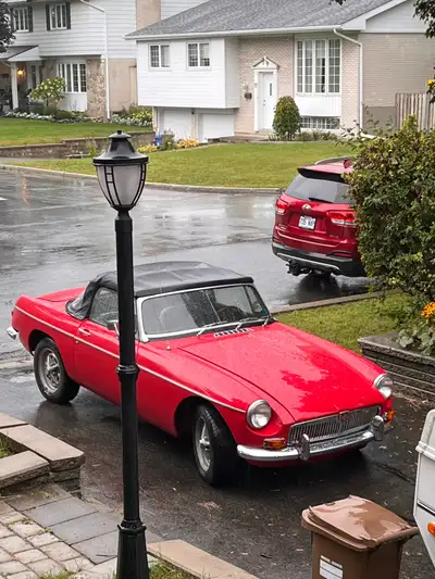 This is a classic red MG MGB convertible in very good condition, offering a true vintage driving exp...