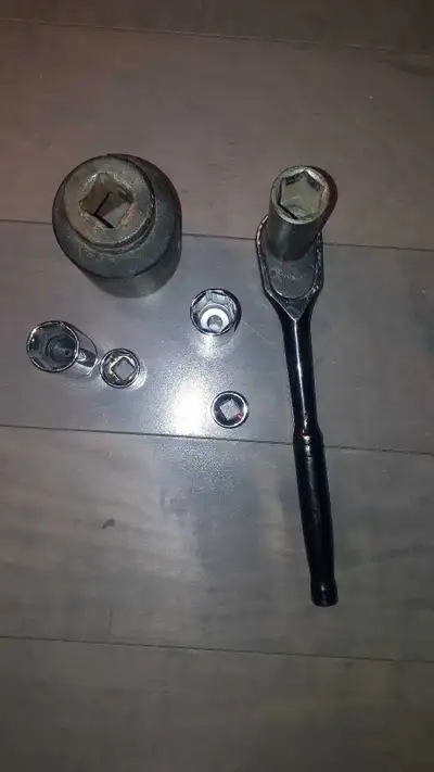 This is a used socket set that includes a variety of socket sizes and a ratchet. The set shows signs...