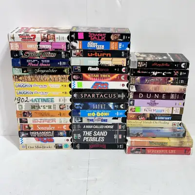 Dive into nostalgia with this collection of 40 used VHS tapes! Each tape promises a trip down memory...