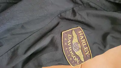 This is a Harley Davidson jacket, size 2XL tall. As can be seen in the pictures, it has numerous Har...