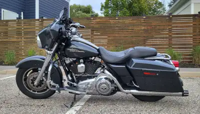 This Harley-Davidson Street Glide is a powerful and stylish touring motorcycle, featuring a sleek bl...