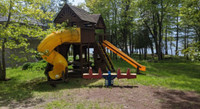 Kids outdoor play structure. Swing, slide, tunnel, picnic table