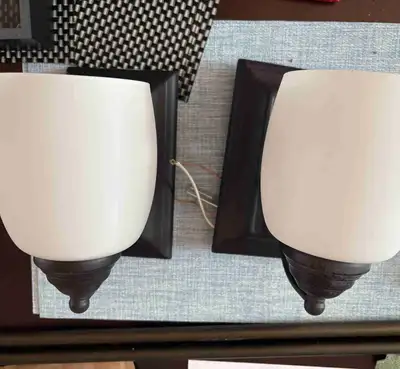 These are a pair of stylish wall sconces that will add a touch of elegance to any room. The sconces...
