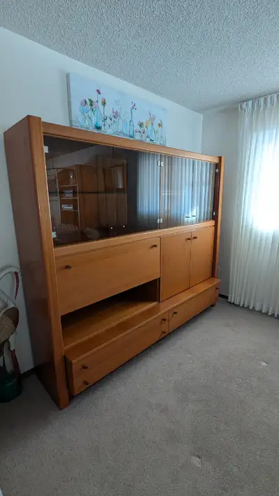 Teak China cabinet in excellent used condition. Three large drawers, two enclosed cabinets, and two...