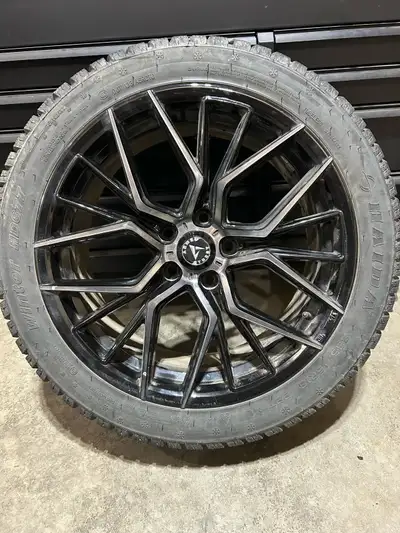 These pre-owned Haida Winter HD677 tires, sized 235/45R18, are mounted on sleek 18x8J black alloy ri...