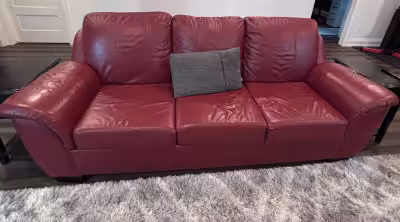 Add a bold pop of color and comfort to your living space with this beautiful red leather sofa. Gentl...