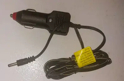 The product is a cigarette lighter power plug/charger with a small pin type end, designed for use in...