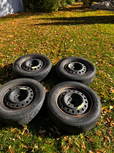 Winter tires on rims from Dodge Grand Caravan. Tire size is 215 70R 16. Rubber is a bit worn. Text m...