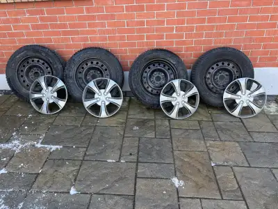 225/65 R17 106T Continental Winter Contact SI plus tires on steel rims. Hubcaps and storage bags inc...