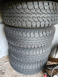 Studded winter tires on black rims