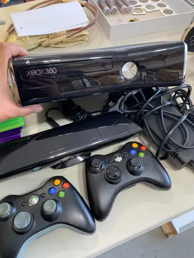 XBOX 360 with Kinect, power adapter, 2 wireless controllers and the following games: 1. Guitar Hero...