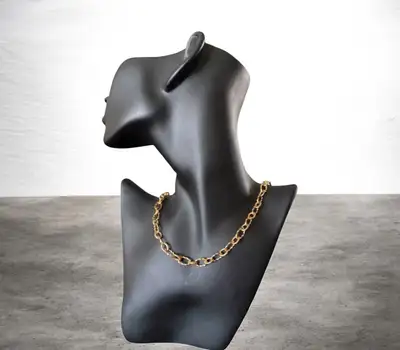 Elegant 18in gold-toned stainless steel necklace has a textured cable link design. The piece is cons...