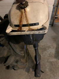 Older outboard motor and metal gas tanks