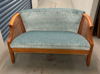 Vintage Loveseat upholstered with rattan cane webbing sides