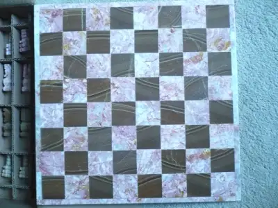 NEVER USED AND STILL IN THE BOX IS THIS BEAUTIFUL MARBLE AND ONYX CHESS SET IN PINK AND BROWN COLOUR...