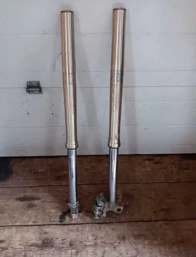 Forks comes with front brake $200 Carburetor and choke cable $100 Triple tree both forks $200 Swing...