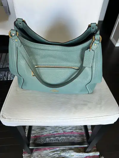 Blue genuine leather coach handbag is for sale., View more