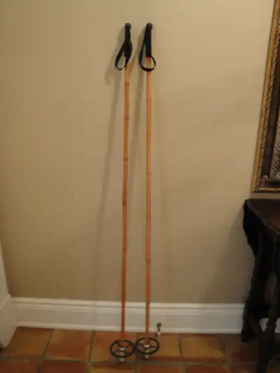 Pair of vintage Nordic. cross country ski poles with handgrips, straps and baskets intact. The poles...