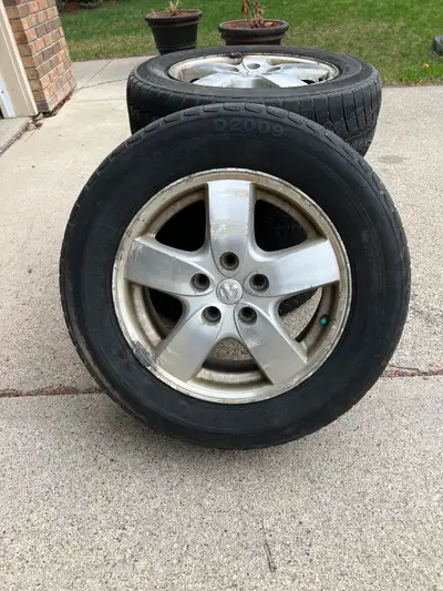 Selling a set of 4 Dodge Grand Caravan rims and tires. The tires are in fair condition and all hold...