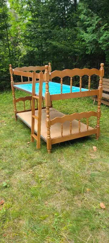 Wooden bunkbeds with ladder. Both are single beds.