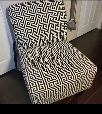 Striking black and white geometric pattern chair, offering a uni, View more
