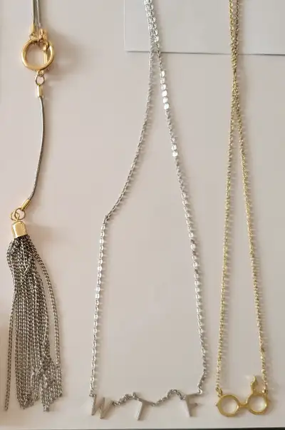$10 for each necklace Left to right in first pic: 1. Long chain tassel 2. "WTF" 3. Harry potter glas...