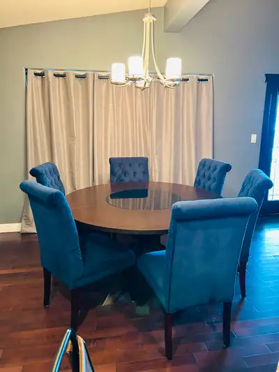 Round 59 inch Dining Table and 6 Blue Velvet Dining Chairs. Excellent condition. Asking $500.00. Cas...