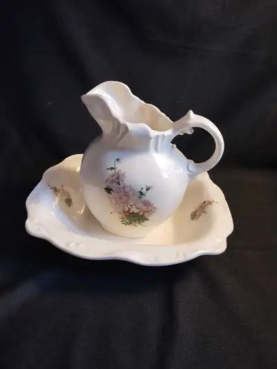 Great pitcher and Bowl set in pristine condition. Bowl is 10 inches by 8 inches; pitcher is 7 inches...
