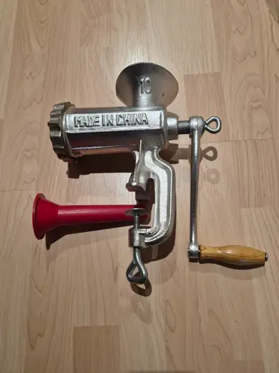 Meat grinder and funnel for making sausages.