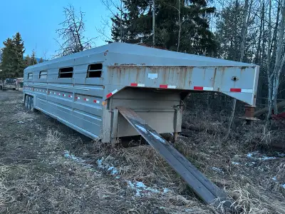 2003 Norbert’s livestock trailer. 3 compartment 3-8000 lb Dexter rubber-ride torsion axles. Air over...