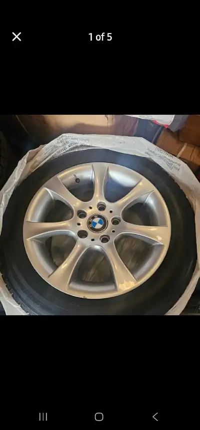 A set of used BMW rims with tires, size 205/55R16. Please note there are some visible scratches on t...