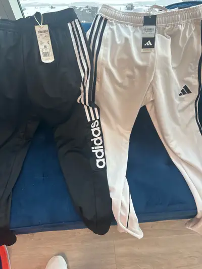 I have a pair of new with tags Adidas track pants in men's small. These athletic pants feature the c...