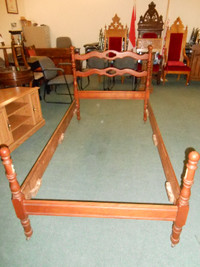 Antique twin bedframe with metal wheels