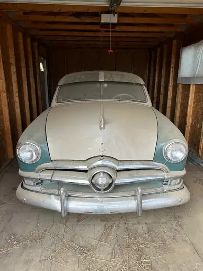 The body has the original paint job. The rear bumper appears to have a small dent. The motor is orig...