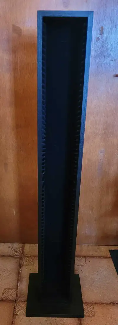 I am selling a black wooden CD storage tower that holds 77 CDs, alongside a wall-mountable rack desi...