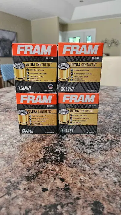 Four Fram Ultra Synthetic Oil Filters. Brand new, unused. 3 are the older style with the wire mesh b...