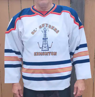 2 older sets of 13 hockey jerseys, one set is Oilers white and the other set is Oilers blue. sizes....