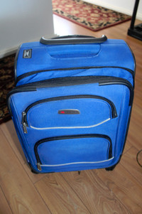 Delsey carry on luggage on 4 wheels with handle and front pocket