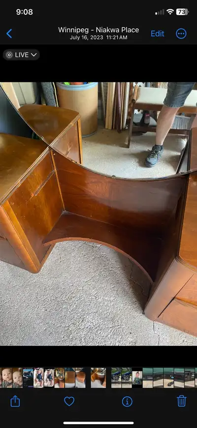 This is a vintage vanity with a round mirror and two side tables featuring one drawer each, all in u...