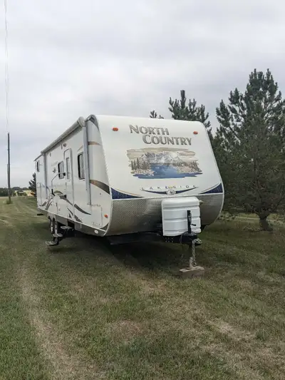 This is a well-maintained, ready-to-camp quad bunk travel trailer in exceptional condition for its a...