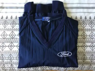 Navy lightweight nylon windbreaker jacket with Ford logo. Has 2 side pockets. Size medium. Packs eas...