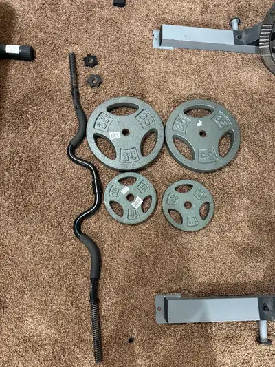 Curling bar -Two 35pound cast iron plates, two 10pound plates, View more