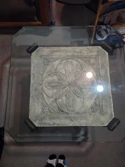 2 - Ornate end tables. Glass top. Metal frame with lion head accents. Intricate stone-like design on...